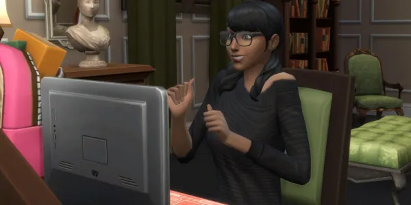   Sims 4 Sim の Cassandra Goth がコンピューターを見て興奮しています。