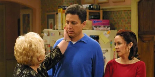   レイモンド's mom touching his face while standing next to his wife on Everybody Loves Raymond